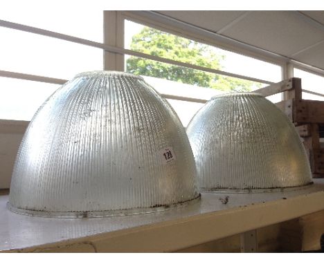 A pair of large industrial ribbed glass ceiling light shades.