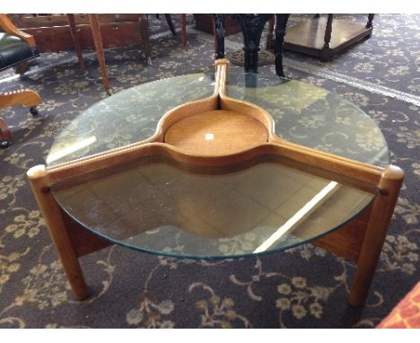 A mid 20th century glass and teak circular Nathan coffee table with adjustable centre shelf.