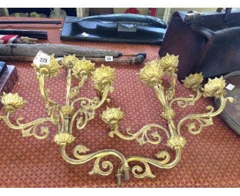 A pair of gold painted five branch brass wall light fittings.