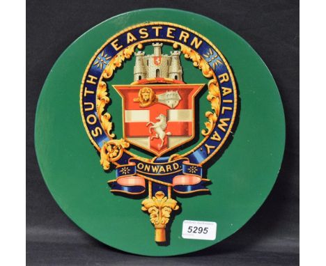 Railwayana - a 'coach panel' roundel with applied arms of the South Eastern Railway, in garter bearing company name and motto