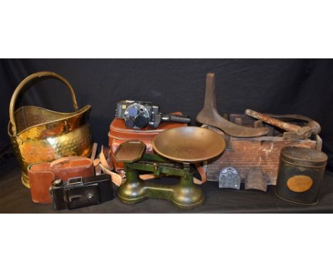 A set of kitchen scales with weights; a brass hammered effect coal scuttle; a set of cobbler's lasts and tools in a wooden ca