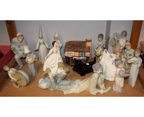 A Lladro figure of a clown lying down; others children as a musical band; others; a Nao breakfast in bed figure; a Beswick mo