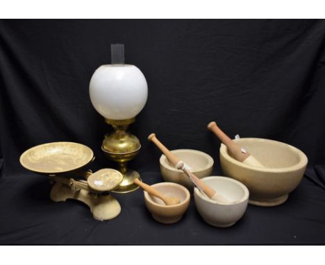 A large Chemist's pestle and mortar; others, similar; a set of kitchen scales; an oil lamp