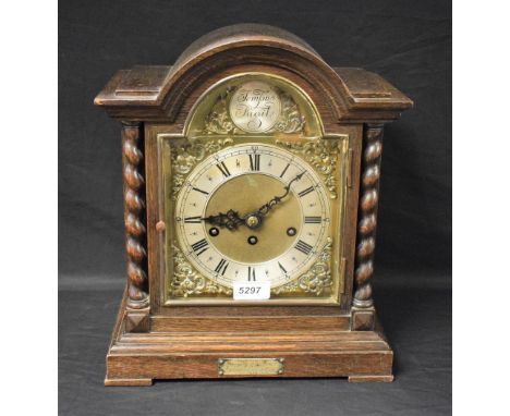 An oak cased mantel clock, Jungens movement, brass dial, part silvered, presentation plaque 1929, key