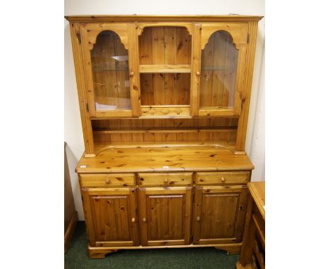 Ducal Pine, a modern kitchen dresser with a sideboard base of cupboards and drawers and a glazed top section with electric li