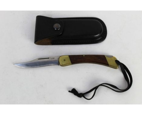 Puma Plainsman folding knife, with a 4" blade marked 970 Puma Plainsman New Stainless Super Keen cutting steel, with brass ha