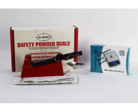 A Lee safety powder scale, together with an electronic scale.