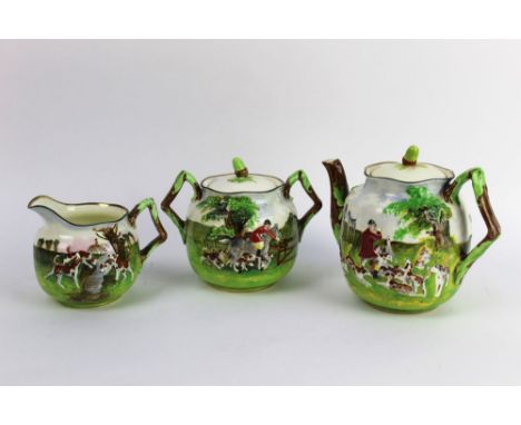 A Royal Doulton three piece tea service, with teapot, sugar basin and cream jug (cream jug AF), depicting a fox hunting scene