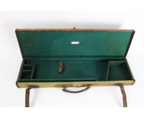 S R Jeffrey & Son Guildford, a canvas and leather trimmed gun case, probably for a small bore gun opening to a green baize li