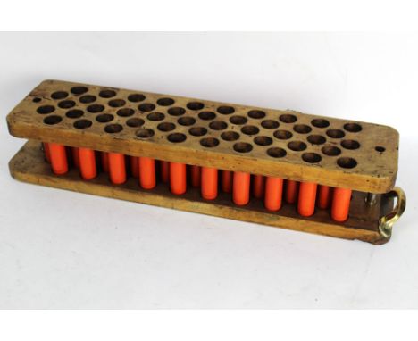 A wooden cartridge reloading tray for fifty cartridges, with Eley, Kynoch cases (primed).  Seventy mixed paper cased collecto