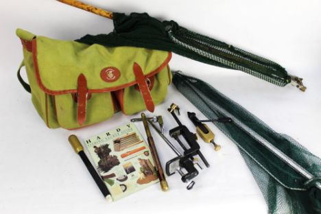 A Guardians Of Game Fishing canvas bag and a Hardy fishing tackle guide, fly tying vices, marrow scoop, landing nets etc.