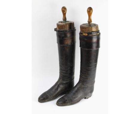 A pair of gentleman's vintage riding boots, with wooden shoe trees.