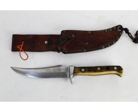 Puma Skinner knife having a 5" blade and marked at the guard 96083, with stag antler handle and leather sheath.  This bladed 