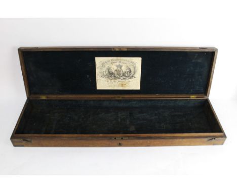 James Wilkinson & Son, an oak and brass gun case opening to a blue velvet lined interior with trade label to lid James Wilkin