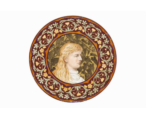 Aesthetic Movement Art pottery chargermanufactured by Derby painted with a Pre-Raphaelite maiden in profile, the rim with a b