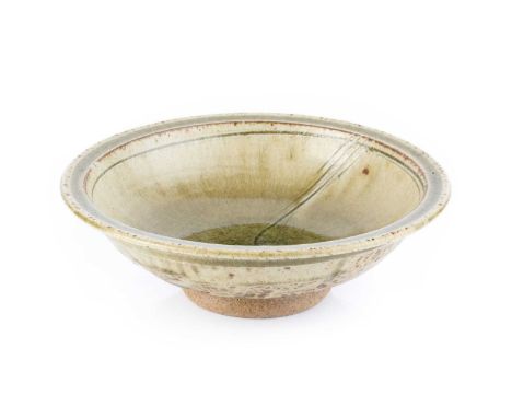 Jim Malone (b.1946)Footed dishwith green ash glaze and incised decorationimpressed potter's seal18cm diameter.Appears in good