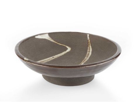 Janet Leach (1918-1997) at Leach PotteryFooted bowlwhite poured glaze on a dark groundimpressed potter's and pottery seals5.5