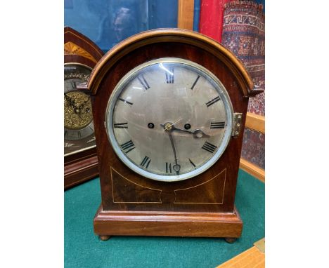 An Antique Mahogany cased mantle clock. Fusie clock movement. Lion head and hoop side hinges. Comes with keys and pendulum. [