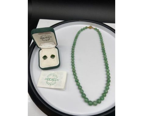 A Vintage jade graduating bead necklace together with a pair of green jade earrings. 