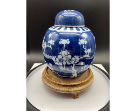 An Antique Chinese blue and white cherry blossom tree design preserve pot with lid. Double blue ring mark to the base. Comes 