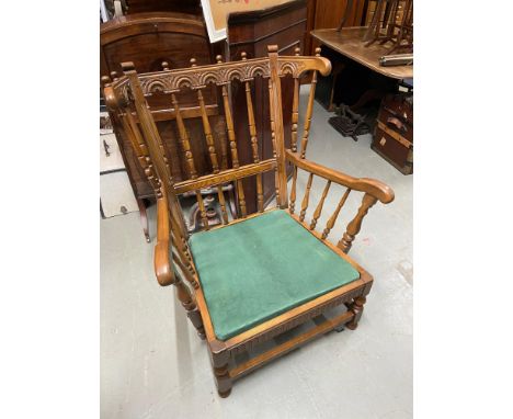 An Ercol elm wood arm chair. Comes with cushions [Needs reupholstered] 