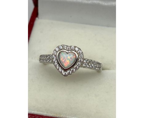 A Silver and CZ Ring with Central heart shaped Opal. [Ring size P1/2] 