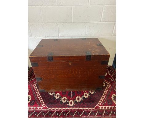 An Antique oak travel trunk fitted with metal bounds , side handles and finished with an interior drawer. [H:61CM X L:93CM X 