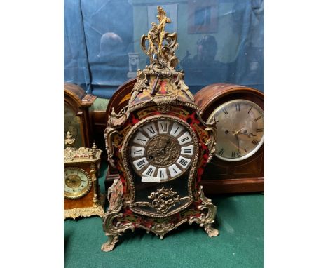 An Impressive Victorian large Boulle Clock and bracket shelf. Designed with a tortoiseshell and brass inlaid body. Brass &amp