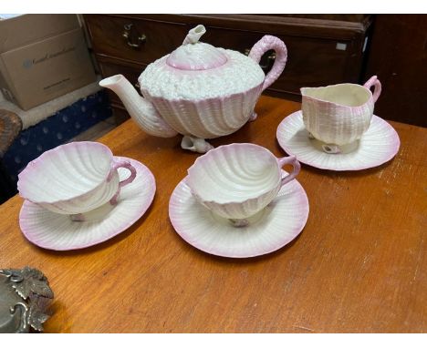 Antique Belleek Neptune Shell design tea pot, two cups, three saucers and cream jug. 