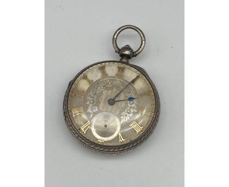 An Antique London silver ornate pocket watch. Designed with gold tone Roman Numerals. Engraved John Forrest, London 23566, Ch