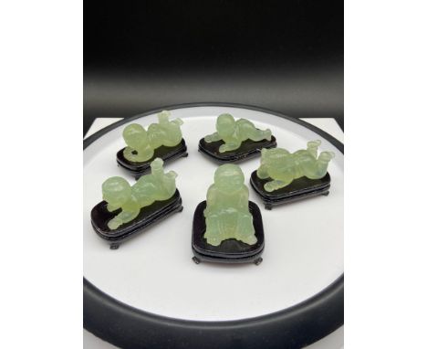 A Lot of five various Chinese hand carved jade children figurines. All come with wooden stands. [Figure laying down 6cm in le