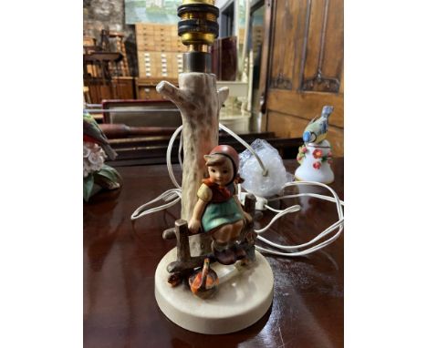 A Vintage Hummel girl sat on a fence figure table lamp. 