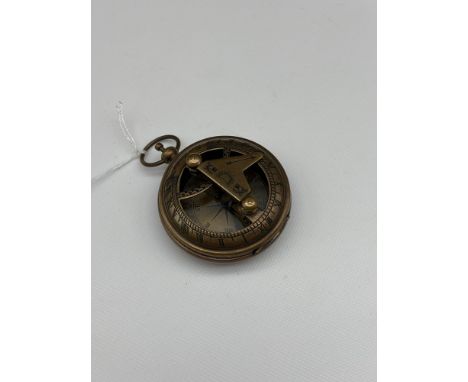 A Brass cased pocket sundial and compass. 