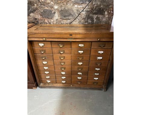 A 20th century Francis Smith Cabinet maker, Glasgow. multi drawer ducet chest. Designed with a wooden roller panel front. [11