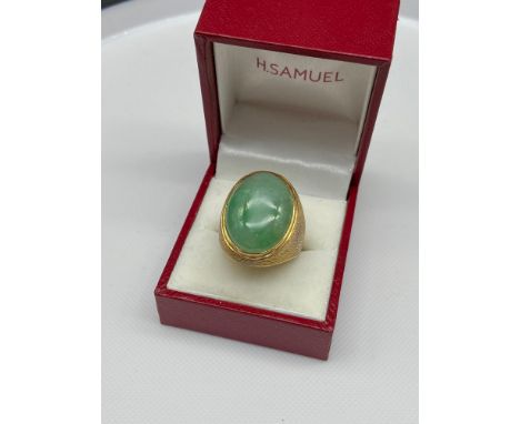 A 585 14ct gold ring set with a large jade set stone. [Ring size R] [12.03Grams] 