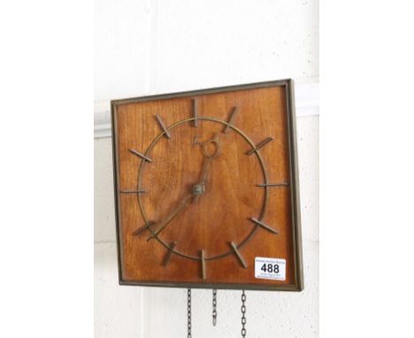 An art Deco style wooden wall clock.