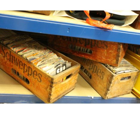 A large quantity of 45 rpm singles of mixed genre contained within 8 vintage wooden Schweppes  boxes. and a quantity of lps.