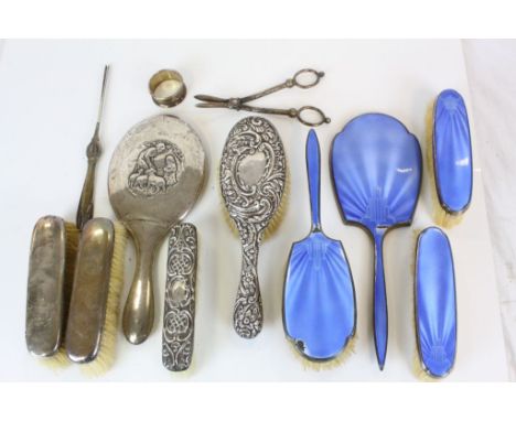 Four Piece Silver and Blue Guilloche Enamel Back Dressing Table Set comprising Three Brushes and a Hand Mirror (some damage t