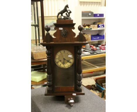 An antique mahogany cased wall clock with two train movement in the vienna style.