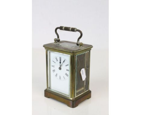 20th century Brass Cased Carriage Clock, the four section glass case with swing handle, the white enamel face with Roman Nume