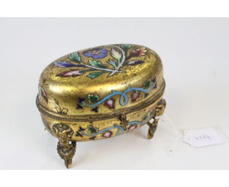 19th / Early 20th century Gilt Metal Oval Trinket / Jewellery Box with Inlaid Enamel Floral Decoration raised on Four Ram's M