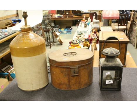 A vintage stoneware bottle converted to lamp, a metal hat box and a hurricane style lamp.