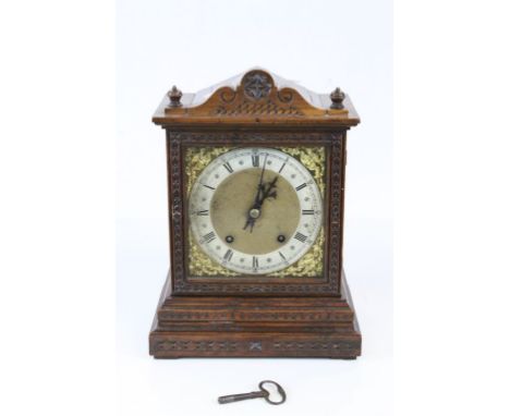Late 19th century Oak Cased Mantle Clock, the Brass and Silvered Dial with Roman Numeral, with key. 32cms high