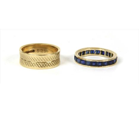 A gold sapphire full eternity ring, with a continuous row of square step cut sapphires, possibly synthetic , channel set to h
