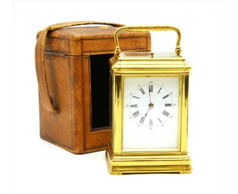 An early 20 th century gilt metal carriage clock, with two train movement and repeater button to an enamel Roman numeral dial