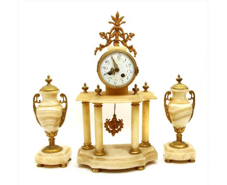 A 19th century alabaster, onyx and gilt metal mantel clock set, with white enamel dial supported on four pillars and serpenti