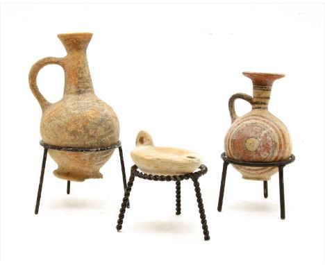 A collection of Cypriot antiquities , to include a single handled flask, a similar painted example and an oil lamp (3)