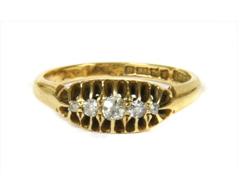 An 18ct gold boat shaped five stone diamond ring, with a row of graduated mixed cut diamonds, claw set to a scalloped gallery