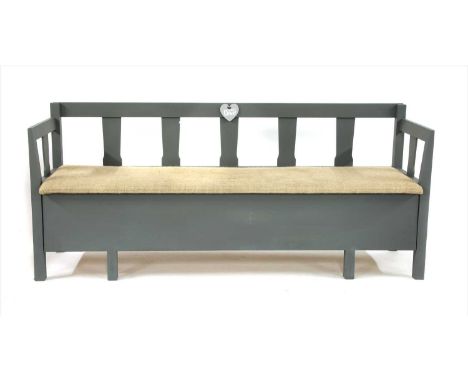 A 20th Century painted pine hall bench, with pierced splat back and arms, the hessian covered seat lifting to reveal storage,