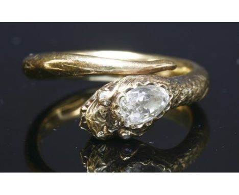 A diamond set gold snake or serpent ring, with a naturalistic coiled snake, with a pear cut diamond, grain set to the top of 